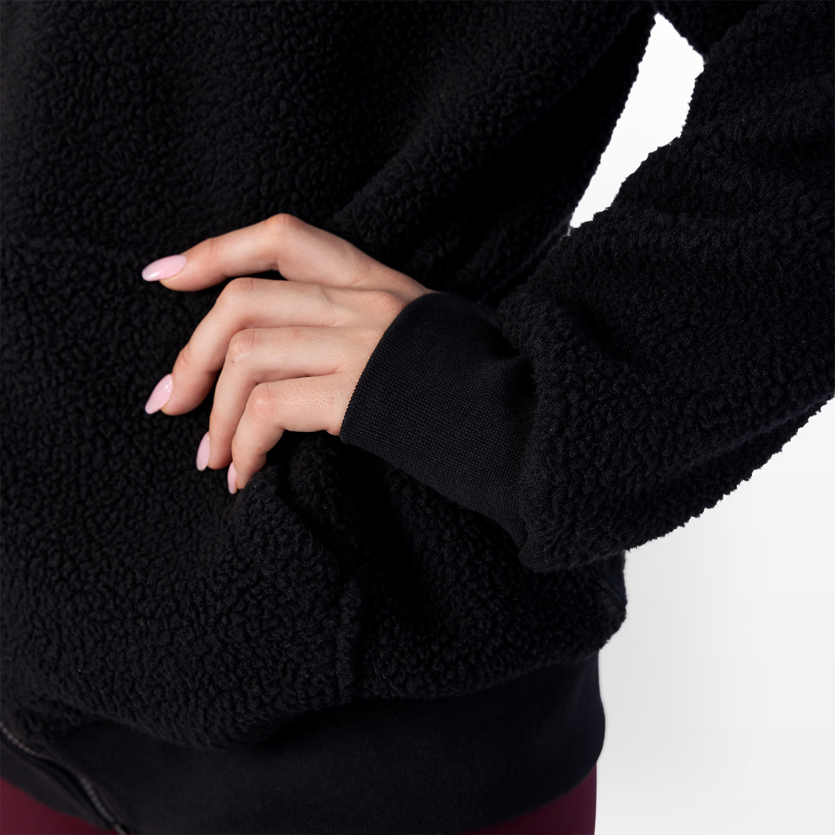 Black sherpa zip-up hoodie sleeve cuff and kangaroo pocket area