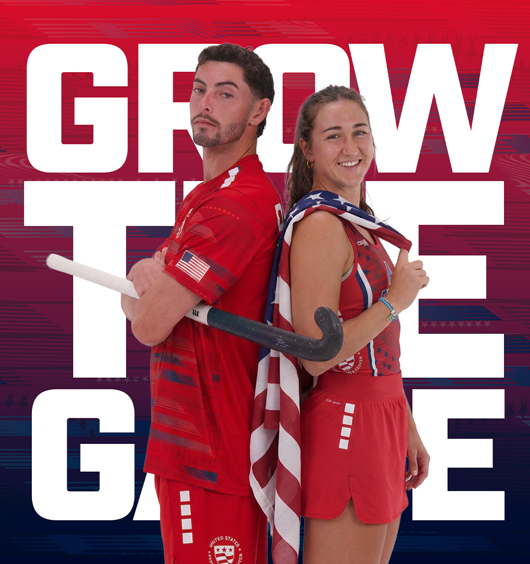 Two female athletes in red USA field hockey uniforms pose back-to-back with a US flag draped over their shoulders, holding a field hockey stick, against a red and blue graphic background with large white text reading 'GROW THE GAME'.