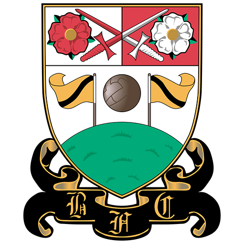 A stylized shield crest with a red top-left quadrant showing a red rose and crossed red and silver swords, a red top-right quadrant showing a white rose, a white center with crossed silver swords, a brown soccer ball, two yellow flags, a green field, and a black scroll at the bottom with gold lettering.