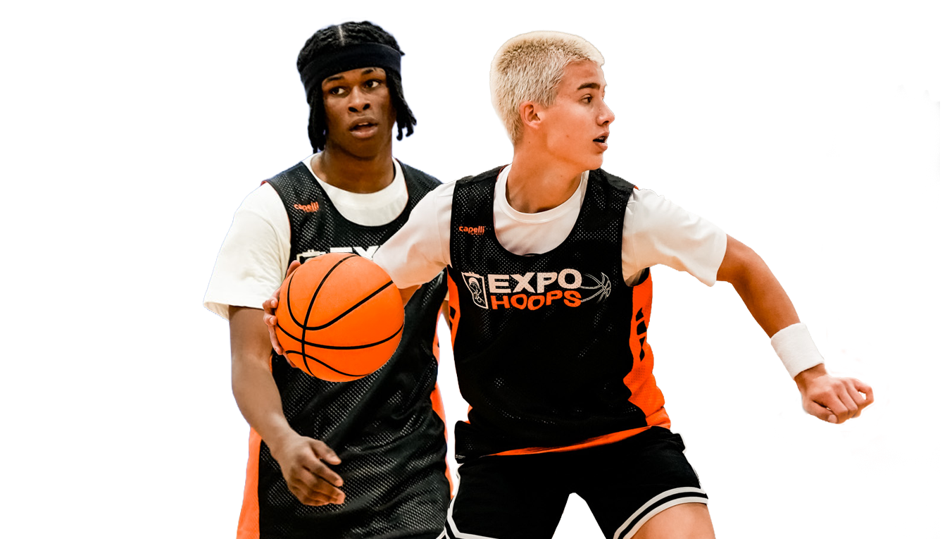 Two basketball players in black and orange team jerseys, one holding an orange basketball, isolated on a solid white background.
