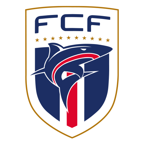 A shield-shaped FCF logo with a stylized shark graphic in navy, red, and white, gold stars, and a gold border on a light gray background.