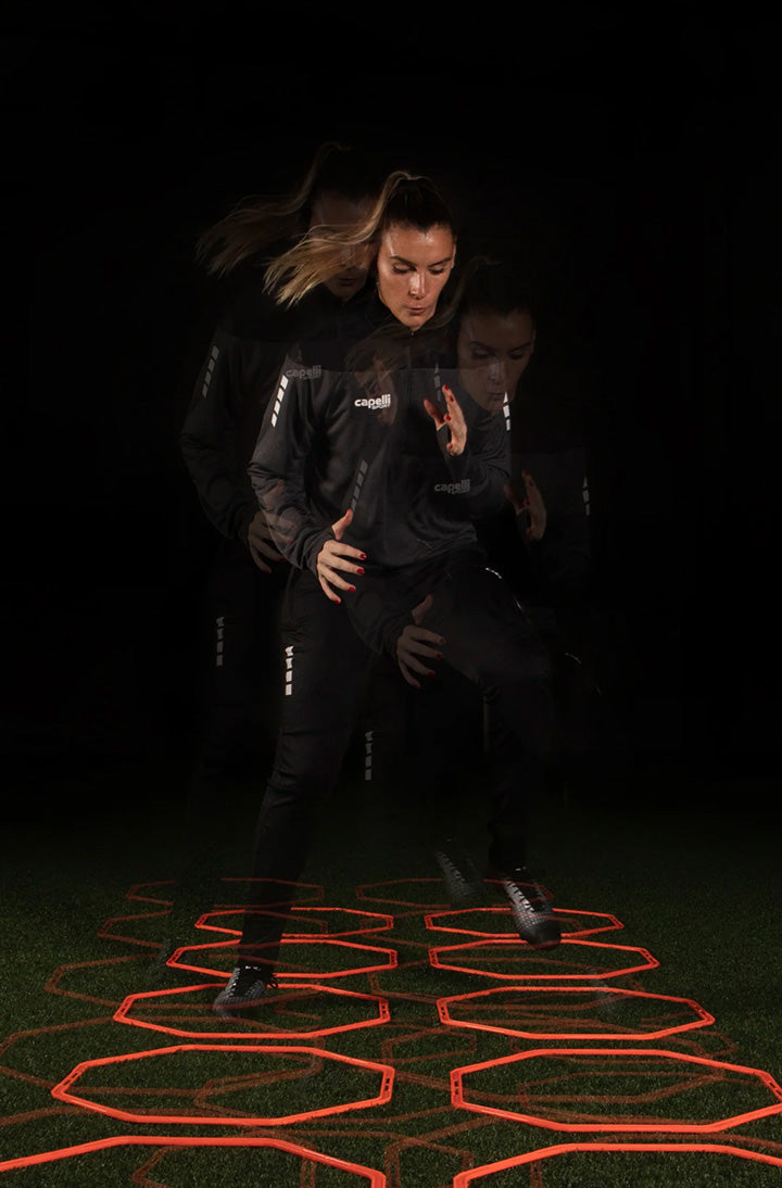 Person running on a dark surface with glowing red patterns