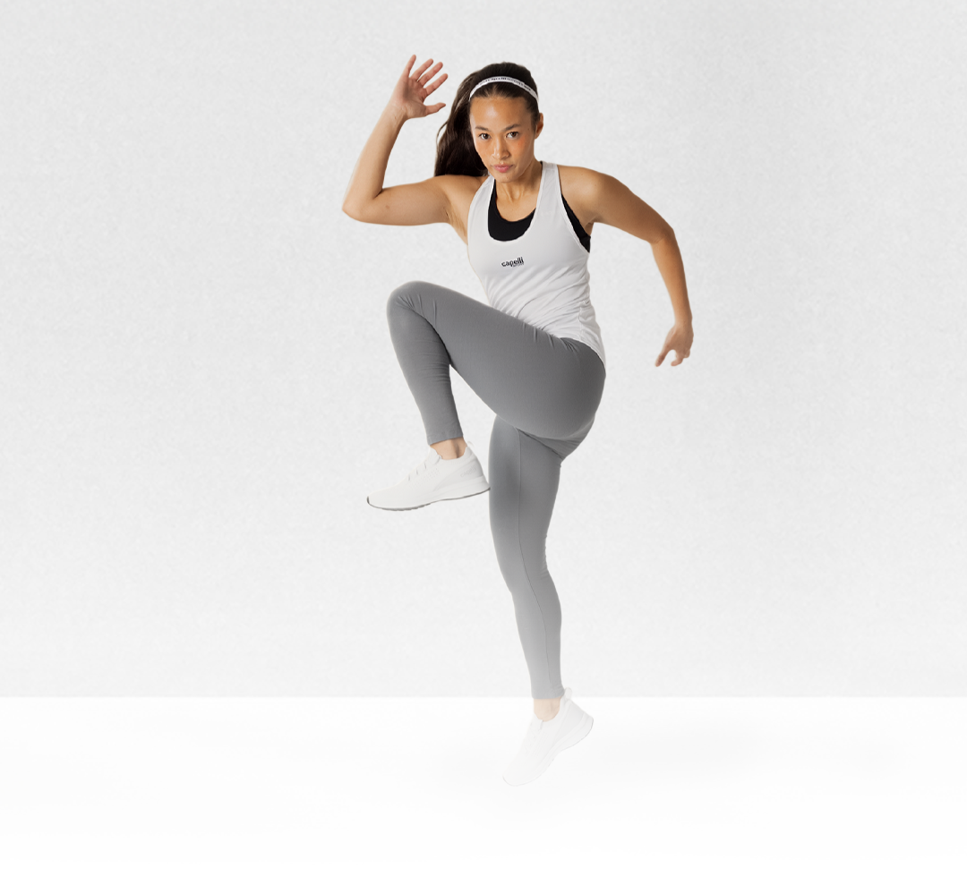 Woman in athletic wear posing on a white background